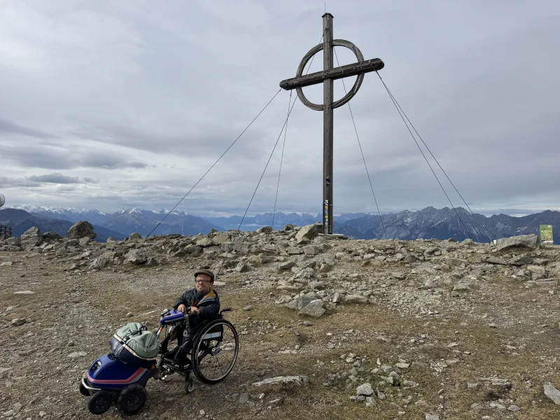 Patscherkofel Gipfelkreuz bei der Sendeanlage. Mit dem Rollstuhl und Swisstrac Zuggerät auf den Berg aufgestiegen